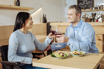 Relaxing mode. Lovely enamoured couple talking while drinking wine