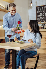 Dreams come true. Inspired cute couple expressing feelings while spending time in a restaurant