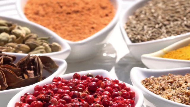 Dry spices on a rotary table. 4K. Macroshooting.