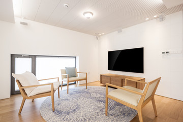 television with wood chair in a white interior