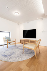 television with chair in a white interior
