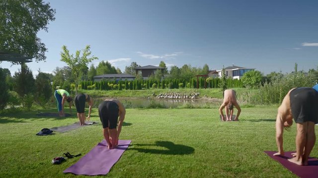 yoga on grass behind walk