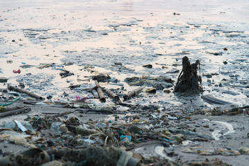 Beach pollution. Plastic bottles and other trash on sea beach
