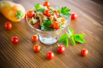 A warm salad of baked eggplant and peppers with cherry tomatoes