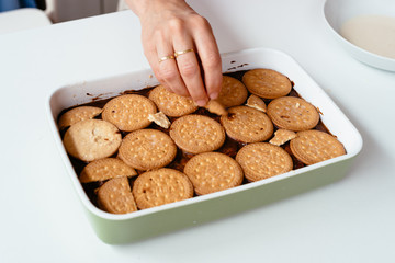 Close up of hand preparing homemade chocolate cake