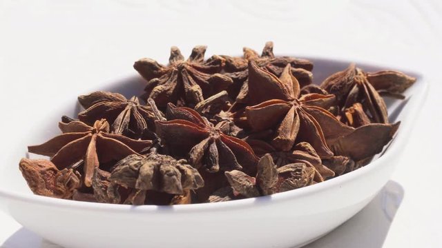 Dry spices anisetree on a rotary table. 4K. Macroshooting.
