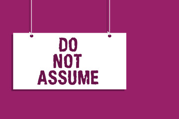 Handwriting text writing Do Not Assume. Concept meaning Ask first to avoid misunderstandings confusion problems Hanging board message communication open close sign purple background.