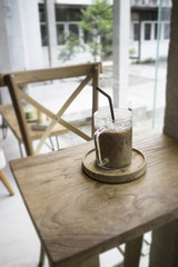 Fototapeta na wymiar Iced milk mocha on wooden table