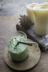 Iced green tea latte on wooden table