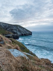 Looking down at the waves crashing on the coast in Trebarwith Strand, Cornwall