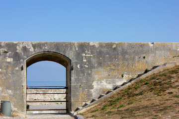 Old door in Fortress of Vauban by the sea, France