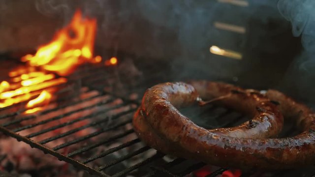 Slow Motion Homemade Sausage Barbecue Cooking And Smoking Closeup High Contrast Cooking Video Charcoal Fire Underneath
