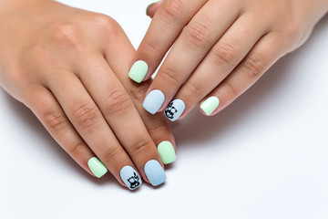 Obraz na płótnie Canvas summer mint blue manicure with painted pandas on short square nails on white background 
