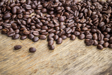 Coffee beans on old wood background