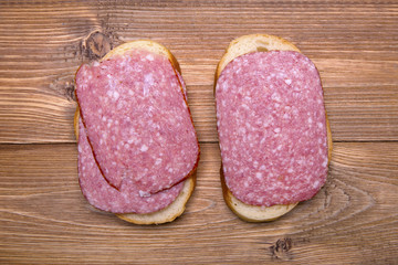 bread with sausage on a wooden table
