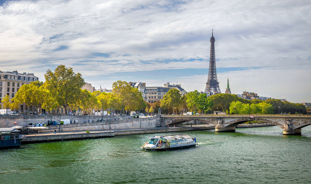 Day view of Eiffel tower, Pont des Arts and Seine river in Paris, France. Architecture and landmarks of Paris. Postcard of Paris