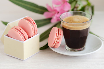 .Black coffee and macarons in box with flowers.Good Morning concept..