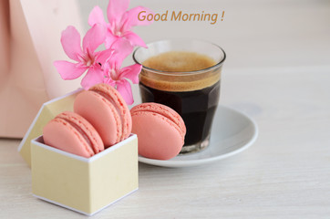 .Black coffee and macarons in box with flowers.Good Morning concept.Copy space.