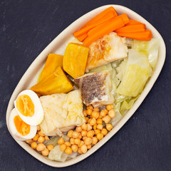 boiled cod fish with boiled vegetables on dish