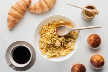 top view of bowl of dry cereal breakfast with various food on white