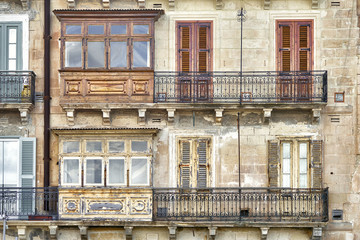 Facade of old maltese house with balconies