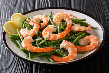 Organic food, salad: shrimps with green beans, cheese and lemon close-up on a plate. horizontal