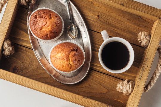 top view of cup of coffee with muffins on tray on white - Powered by Adobe