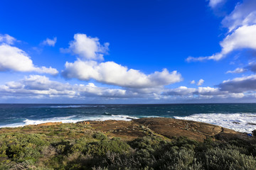 Ocean view against blue sky as seen from Cape Leeuwin lighthouse attraction at western australia