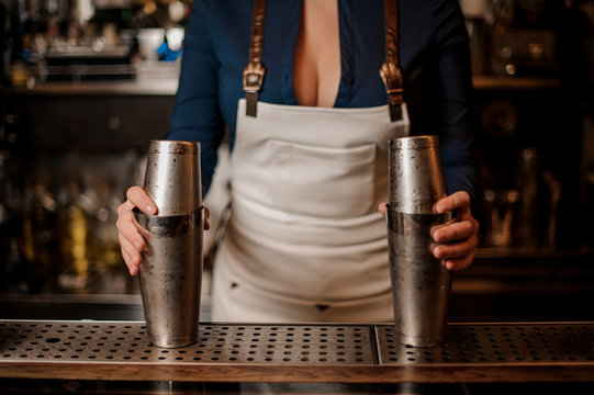 Barmaid with a beautiful deep neckline holding shakers