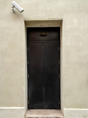 A door with a security camera, seen in Shrewsbury, Shropshire, England, UK