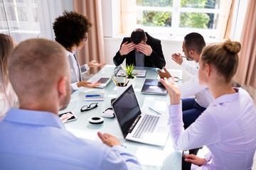 Businesspeople Blaming Their Colleague In Office