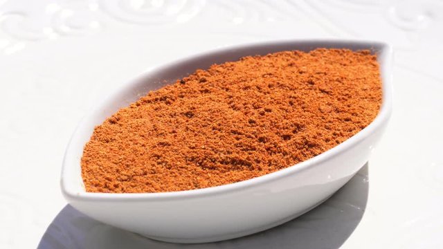 Dry spices paprika on a rotary table. 4K. Macroshooting.