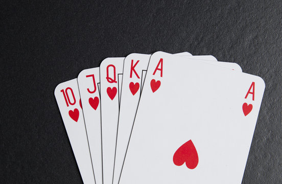 Royal flush in hearts on a black background