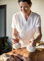 Female message therapist giving a massage