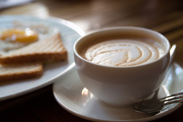 a cup of cappuccino with toasts on a background