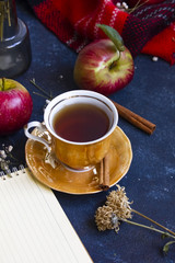 A cup of tea with apple and cinnamon in autumn