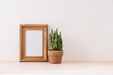 Fototapeta premium mock up frame with cactus pot on wooden floor