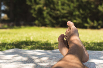 Legs lying on the grass resting on a summer day