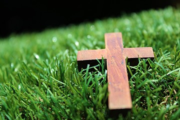 Blurred image. Christian crosses made of wood on a green background.