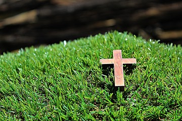 Blurred image. Christian crosses made of wood on a green background.
