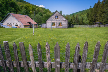 Fototapeta na wymiar Wooden cottage in former village Brzegi Gorne in Bieszczady National Park, Subcarpathian Voivodeship of Poland