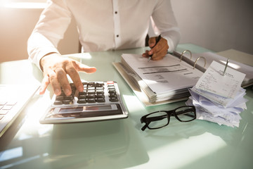 Businessman calculating bill