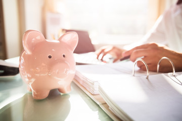 Close-up of a piggybank on reflective desk