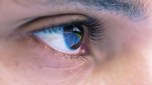 reflections of a blue running stadium in a athletes  eye