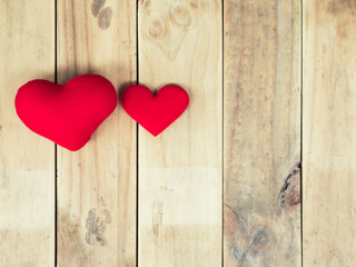 Red heart lay on old wood background.