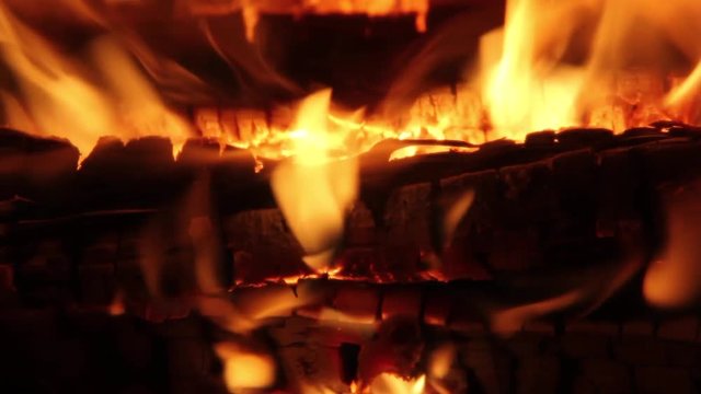 Burning Firewood Coal Close up in the Fireplace. Fire Fireplace Ember Wood Home Embers Closeup. Glowing Embers in Hot Red Collor. static tripod shoot.