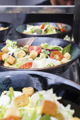 Greek salad served in black plates.