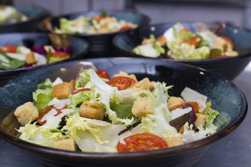 Greek salad served in black plates.