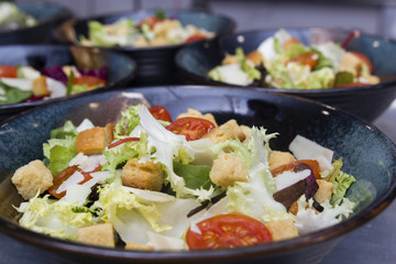 Greek salad served in black plates.