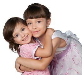 Portrait of beautiful girls hugging and posing while looking at